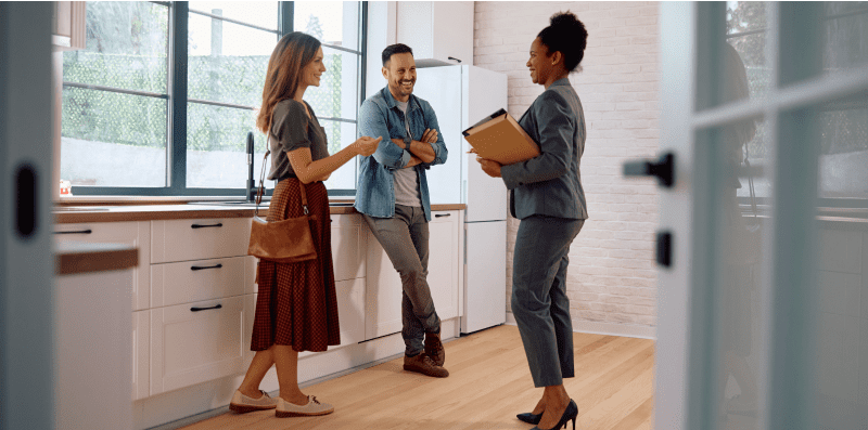 A group of people standing around talking.