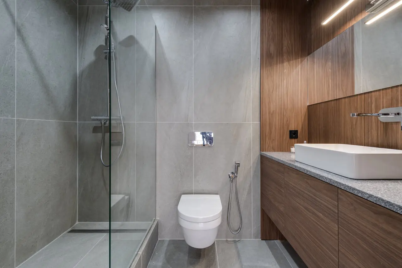 A bathroom with a toilet and shower in it