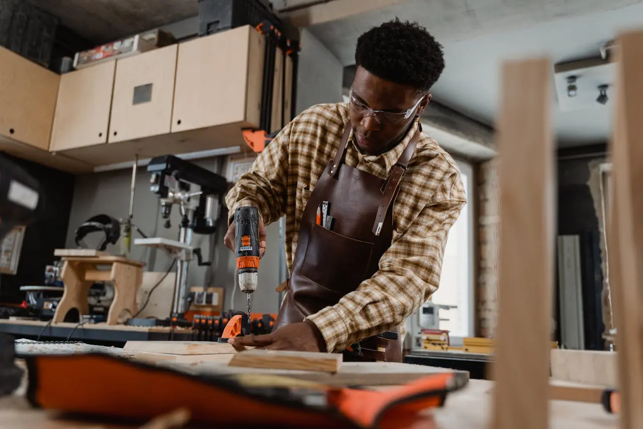 A man in an apron is working on a project.