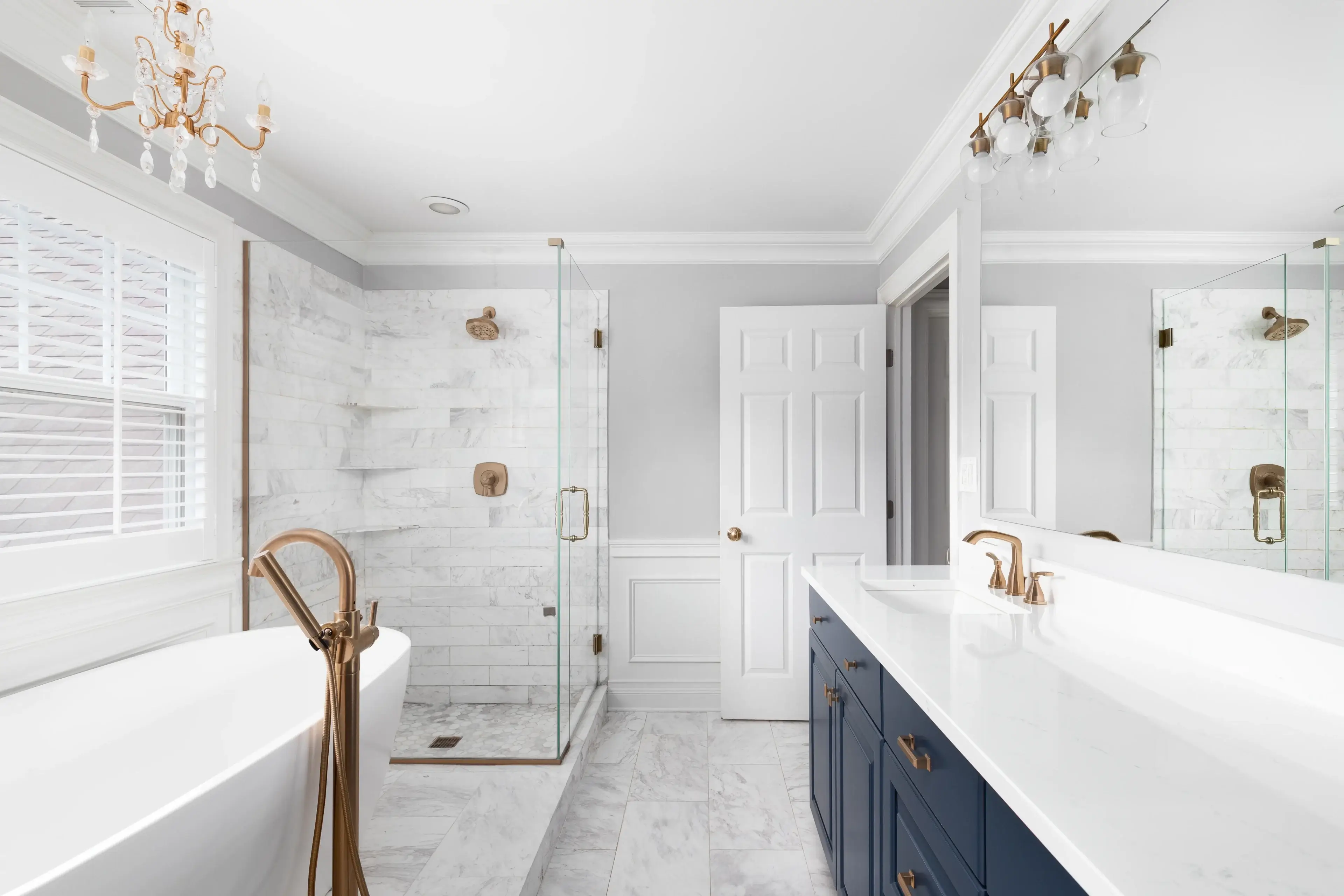 A bathroom with two sinks and a walk in shower.