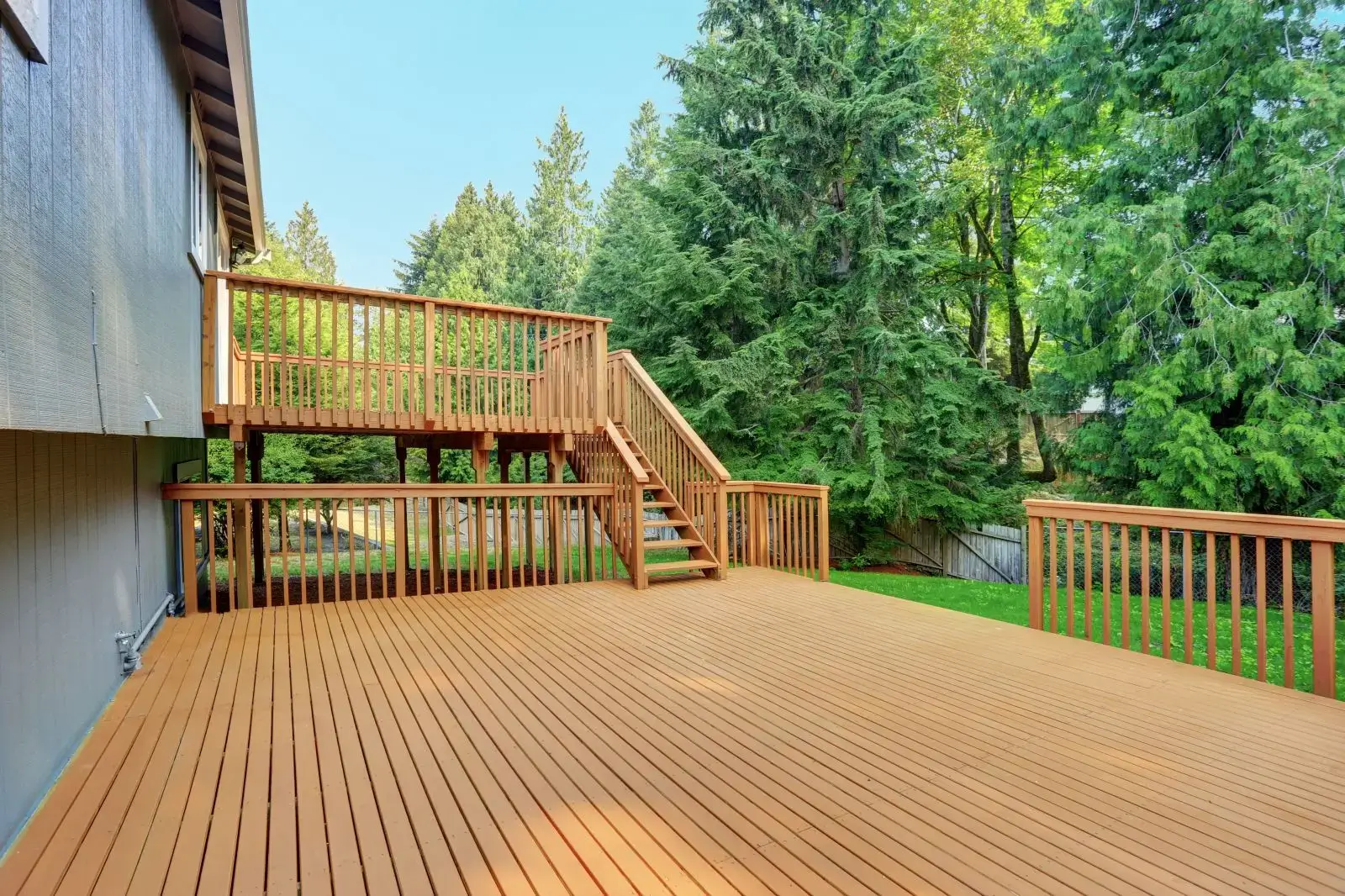 Spacious wooden backyard deck with stairs