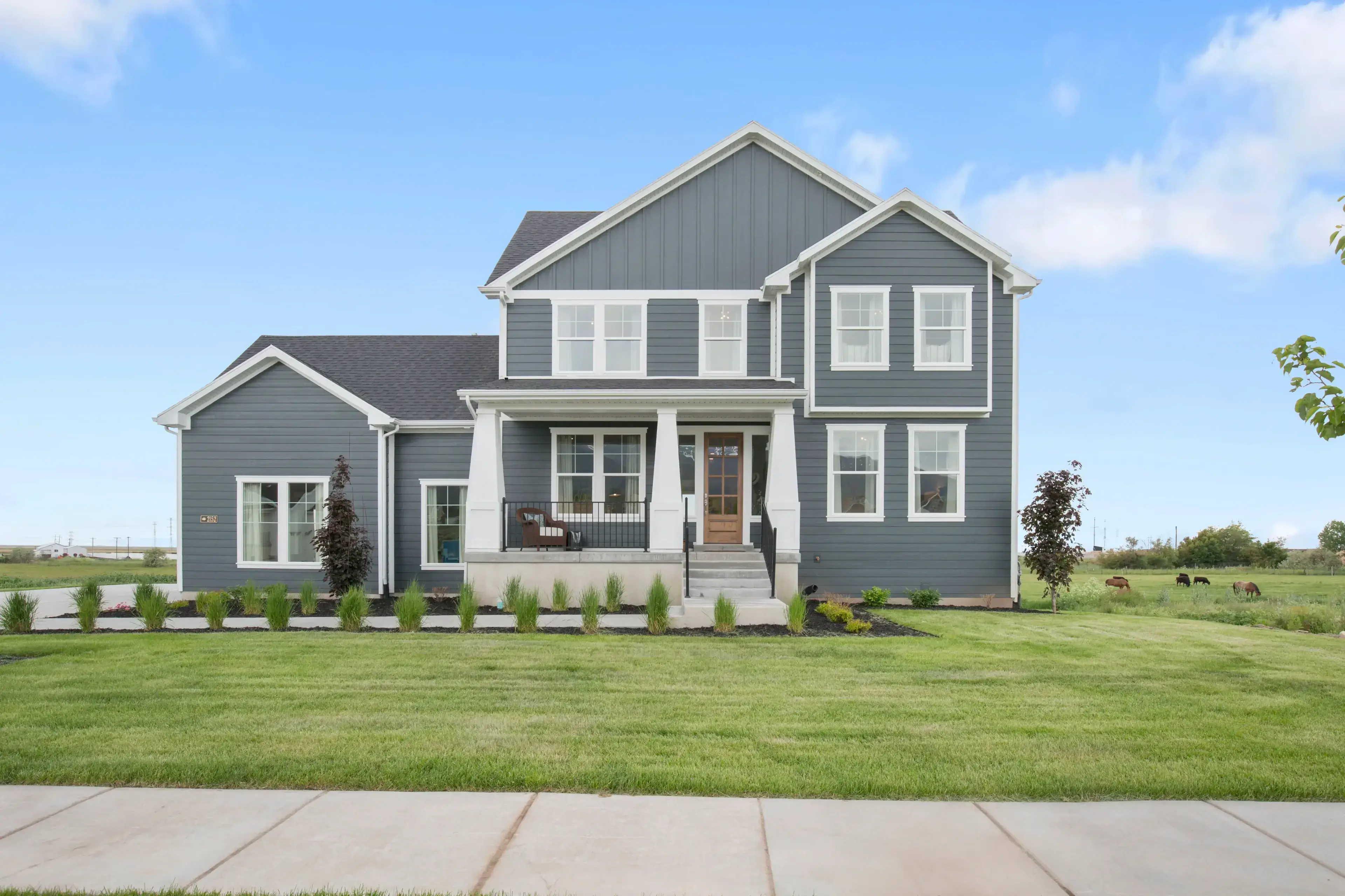 Blue-gray two-story suburban house with porch