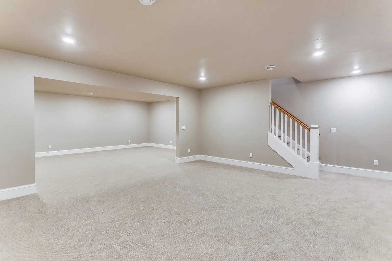 Spacious finished carpeted basement with staircase
